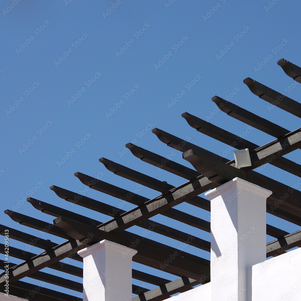 Trellises on a white Spanish retro style public parking structure under