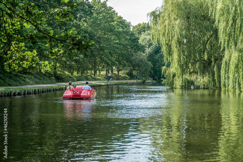 Vászonkép People on a pedal boat sailing on a river in the Munke Mose Park, Odense, Denmar