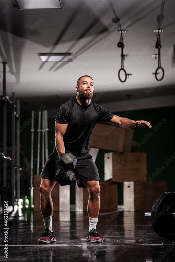 Muscular athlete lifting very heavy weights. Man working out indoors. Muscular athlete lifting very heavy weights. Man working out indoors.