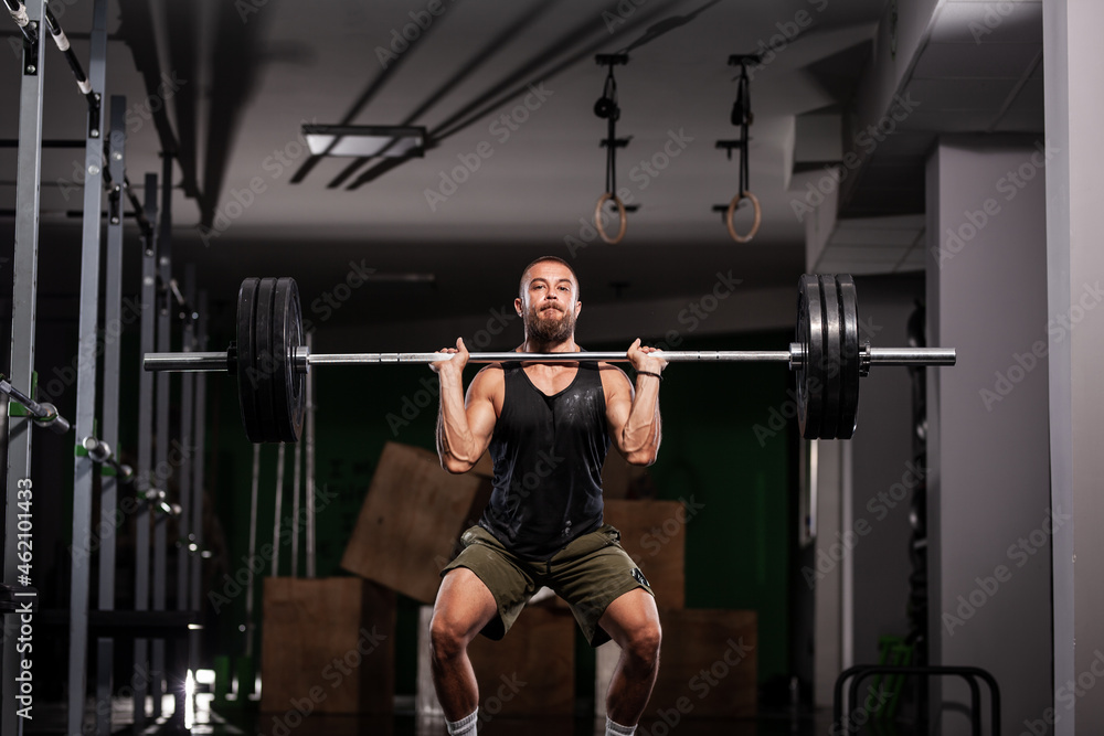 Fototapeta premium Muscular athlete lifting very heavy barbell