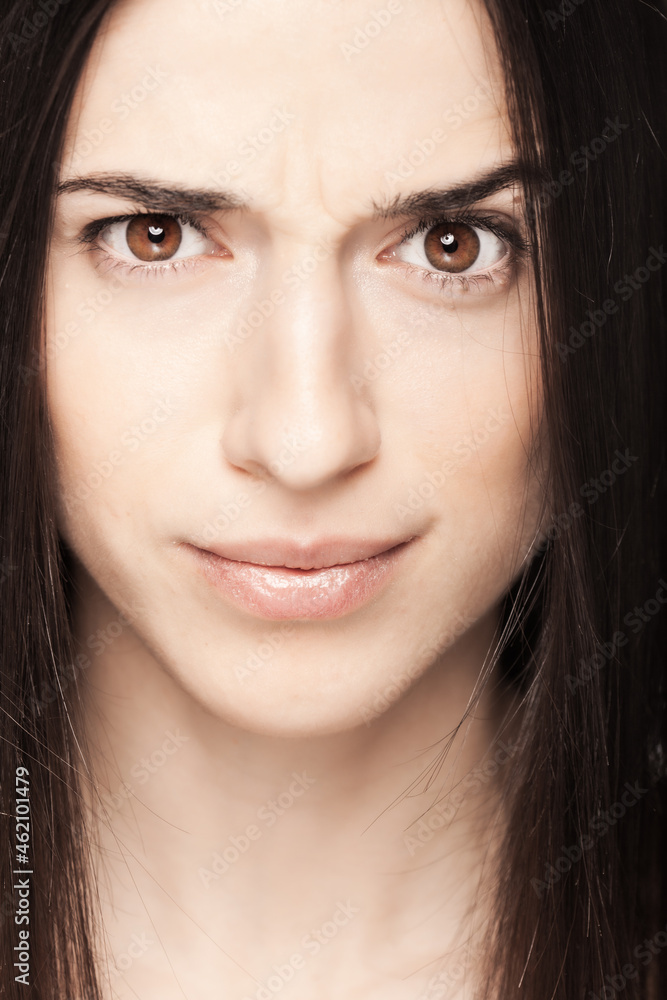 Portrait of a beautiful brunette girl looking at camera with face expression. Portrait of a beautiful brunette girl looking at camera with face expression.