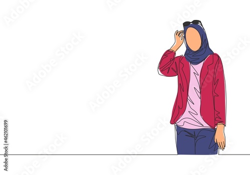 Single continuous line drawing of young happy muslimah girl on headscarf holding glasses on head. Attractive malay women model in trendy hijab fashion concept one line draw design vector illustration
