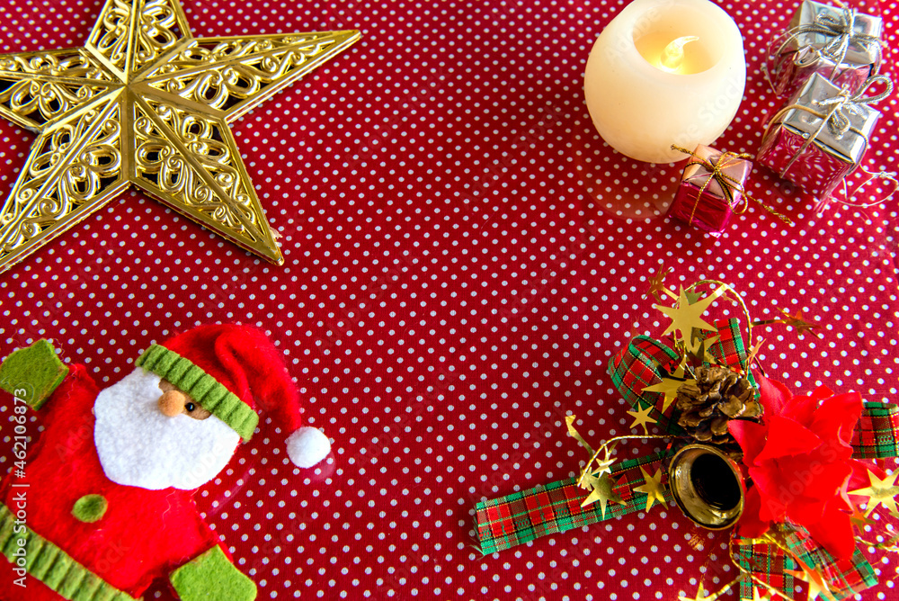 Fototapeta premium Christmas figures and Christmas decoration on red background.