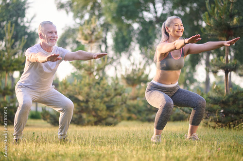 A man and a woman exercising in the park