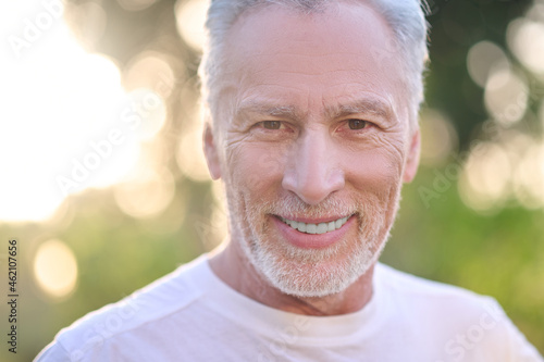 A picture of a gray-haired man looking confident