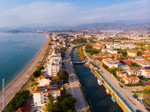 Scenic aerial view of modern cityscape of Fethiye along shoreline of Aegean Sea on sunny winter day, Turkey © JackF