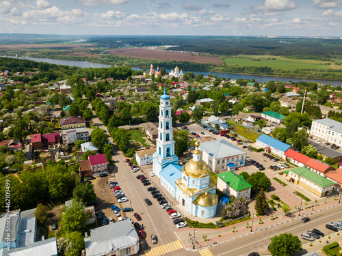 Aerial view of Russian town of Kashira on bank of Oka River overlooking golden dome and multileveled belfry of Vvedenskaya church photo