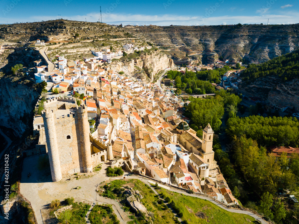 View of Alcala del Jucar, medieval Spanish village above gorge of Jucar river on spring day