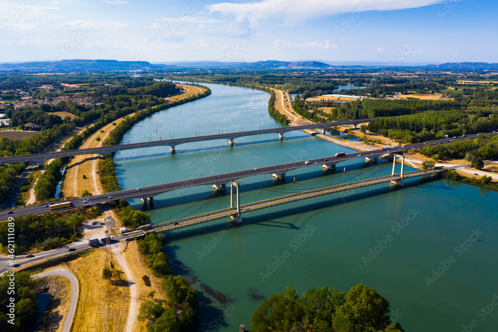 Picturesque aerial view of Rhone river with three bridges near small town Roquemaure in Gard department of southern France
