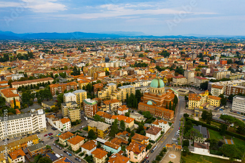 Aerial view of Udine cityscape overlooking residential areas and ossuary temple of Fallen of Italy (Tempio ossario) in autumn day