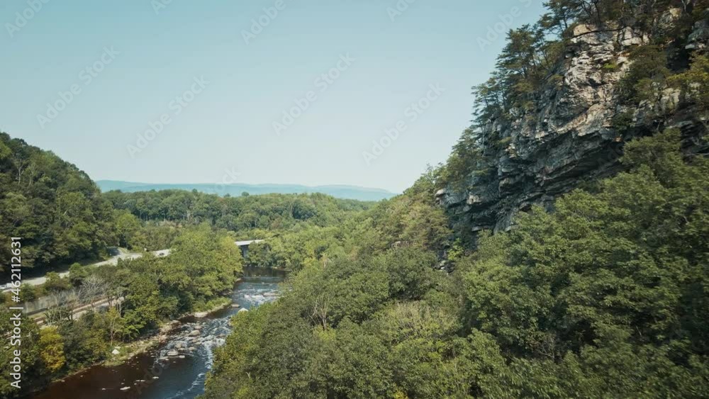 Aerial 4K view of a drone flying over a forest close to the trees and next to a river in a countryside landscape in Northern Virginia, USA. Aerial 4K view of a drone flying over a forest close to the trees and next to a river in a countryside landscape in Northern Virginia, USA.