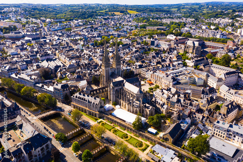 Aerial view of center of Quimper on banks of Odet River overlooking of Cathedral of Saint Corentin in summer, Finistere, France.. photo