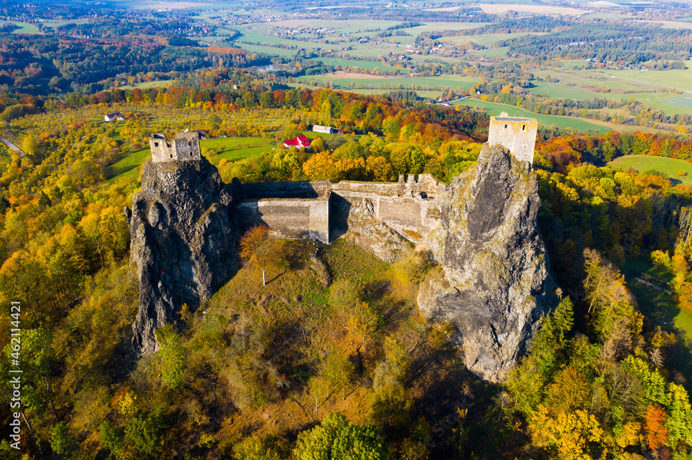 Impressive autumn landscape of Bohemian Paradise overlooking ruins of medieval Trosky Castle on tops of two stone crags, Czech Republic..