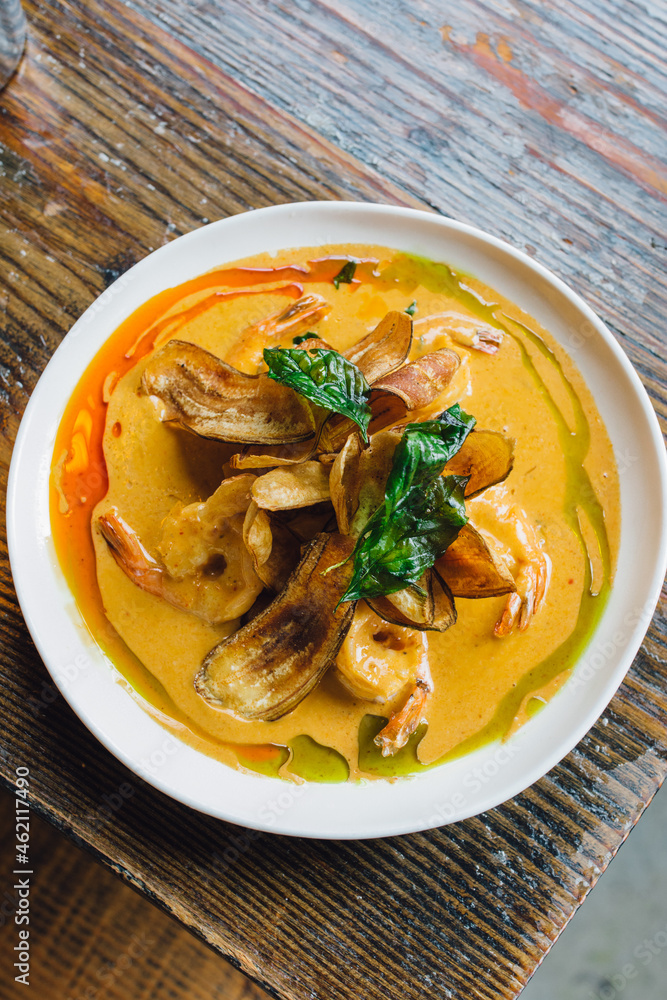 Thai Spicy Curried Prawns with coconut milk curry, lime leaf, banana chips Thai Spicy Curried Prawns with coconut milk curry, lime leaf, banana chips
