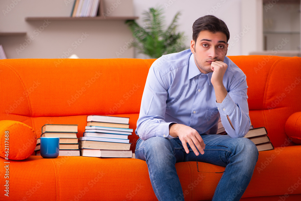 Young male student preparing for exams at home