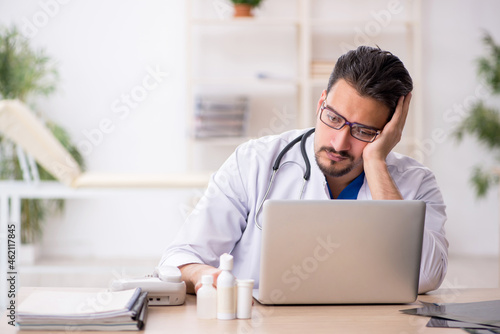 Young male doctor in telemedicine concept