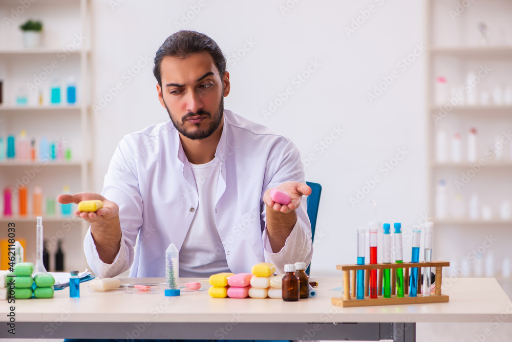 Young male chemist testing soap in the lab Young male chemist testing soap in the lab