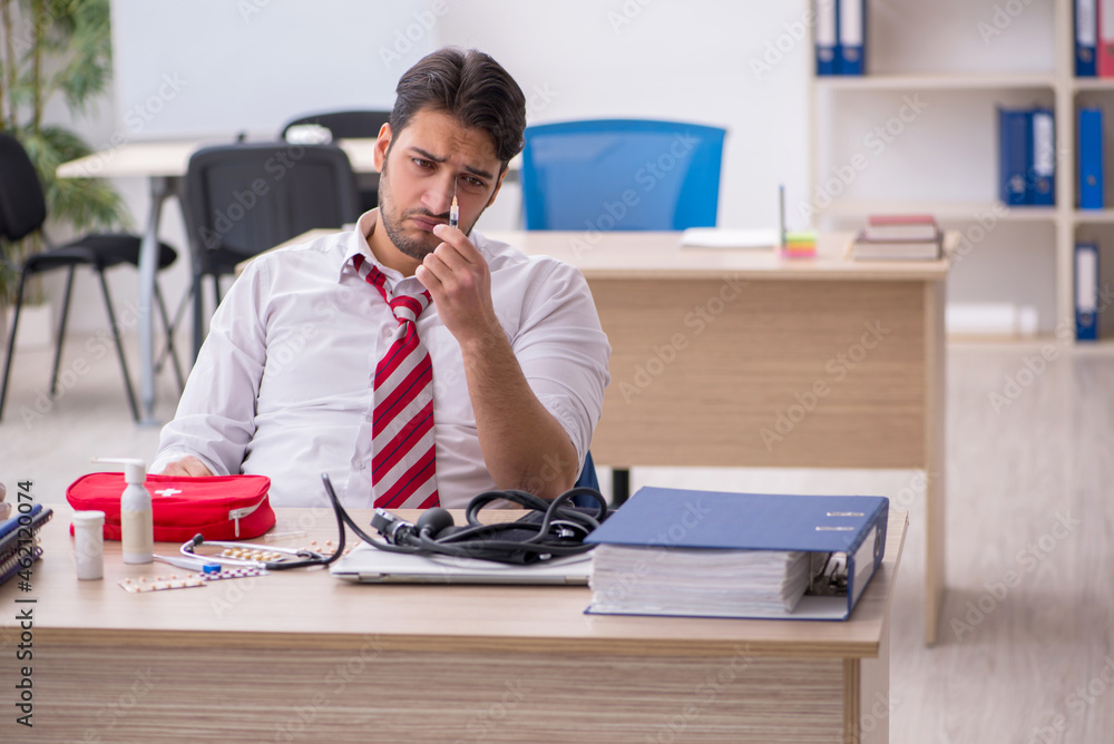 Young male employee suffering at workplace Young male employee suffering at workplace