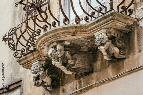 Beautiful baroque mascaron ornament of a balcony in the old town of Ragusa, Sicily