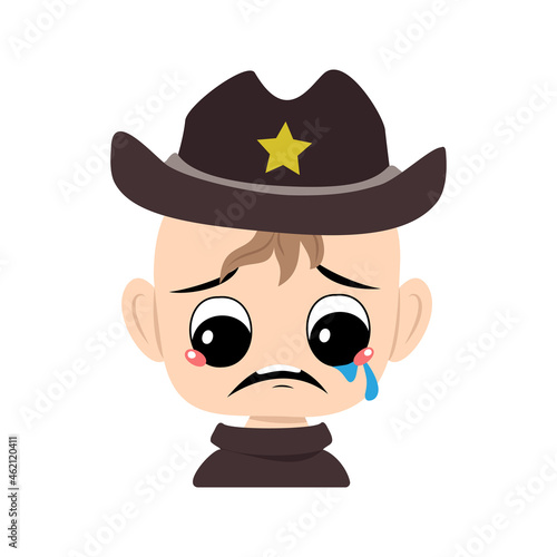 Boy with crying and tears emotion, sad face, depressive eyes in sheriff hat with yellow star. Head of cute child with melancholy expression in carnival costume for the holiday