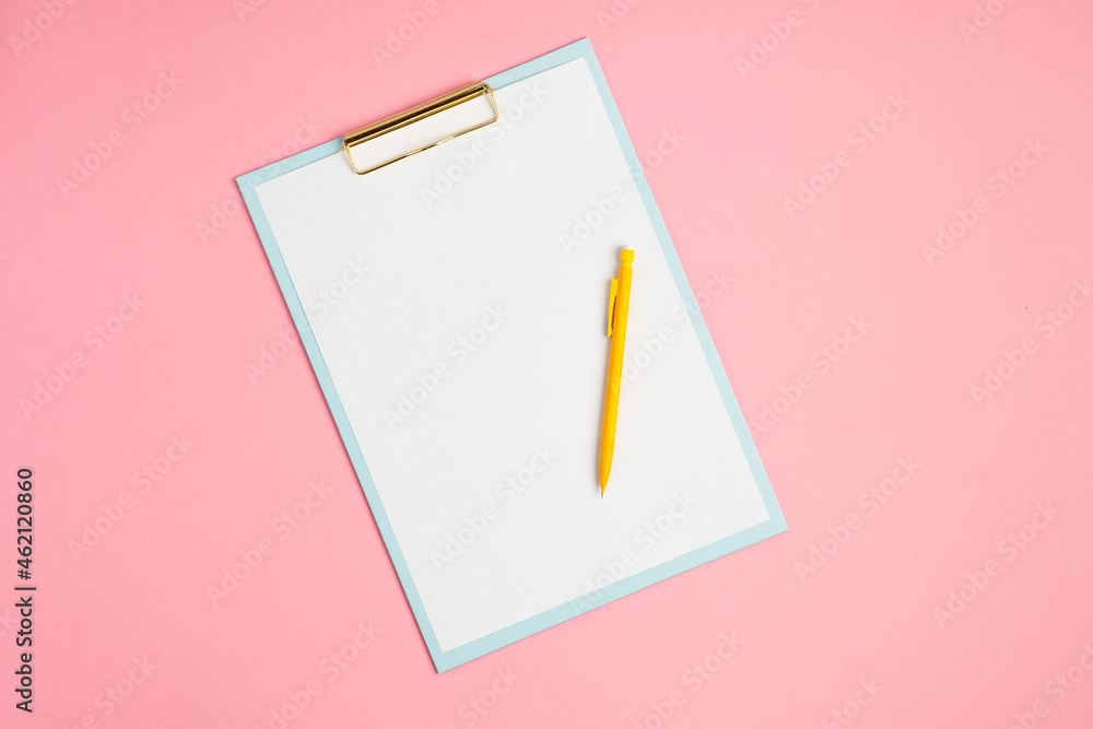 Pink workspace with blank clip board and pencil Pink workspace with blank clip board and pencil