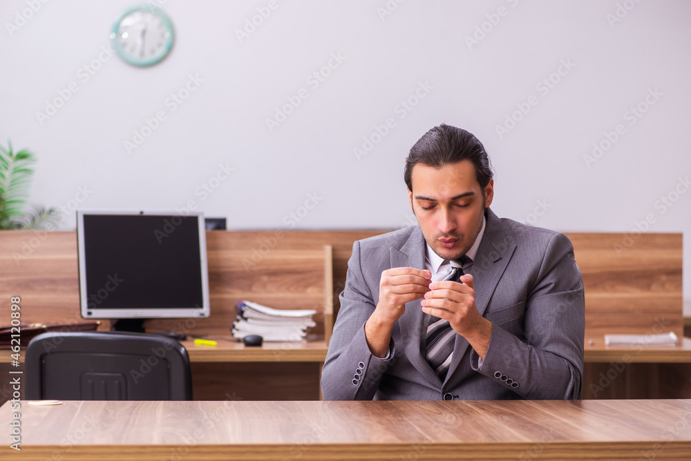 Young businessman employee sitting in the office Young businessman employee sitting in the office