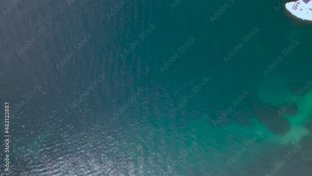 Overhead drone clip of crystal waters and beach with boats in the bay of Vourvourou, Halkidiki, Northern Greece. 4K Overhead drone clip of crystal waters and beach with boats in the bay of Vourvourou, Halkidiki, Northern Greece. 4K