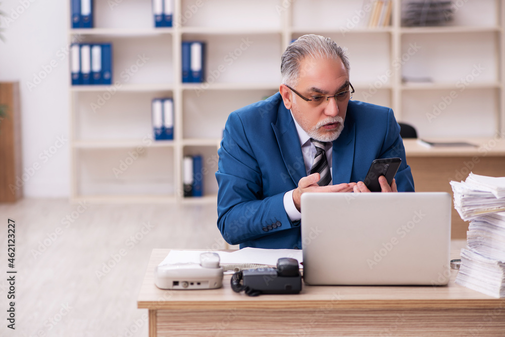 Old male employee and too much work in the office Old male employee and too much work in the office