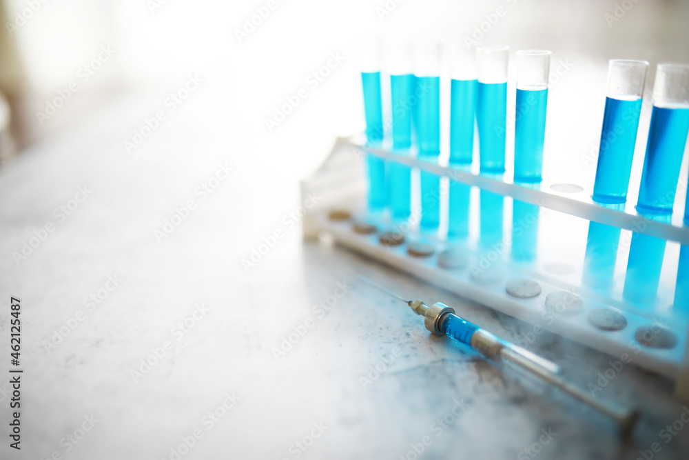Vaccine vial search concept on table. Close up Vaccine flaskl for prevention,immunization and treatment. Vaccine vial search concept on table. Close up Vaccine flaskl for prevention,immunization and treatment.