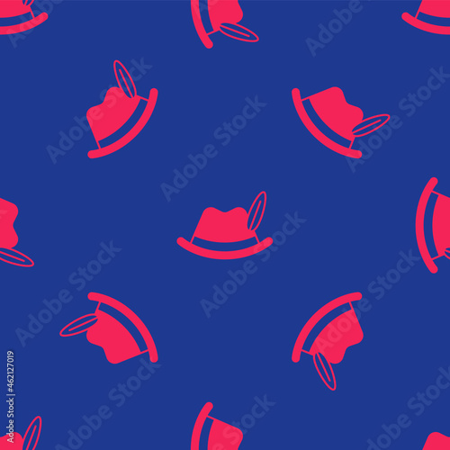 Red Oktoberfest hat icon isolated seamless pattern on blue background. Hunter hat with feather. German hat. Vector