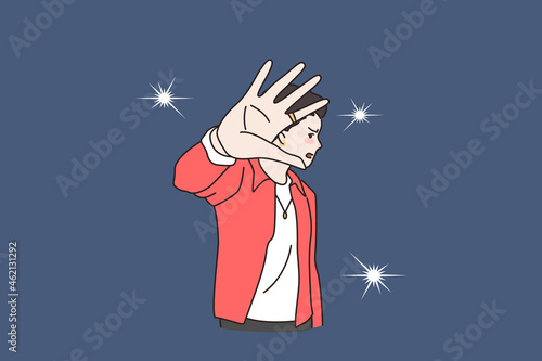 Unhappy young man celebrity annoyed by camera flashes photographers making. Distressed angry male star bothered reporters journalists, make stop hand gesture. Flat vector illustration.