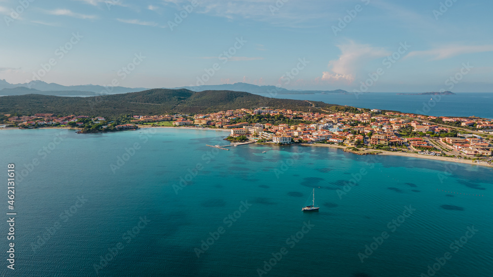 the picturesque coastal village of Golfo Aranci in northern Sardinia. perfect for vacations, beautiful beaches, clear blue water. Boats and yachts anchored on the jetty. drone aerial view Italy.