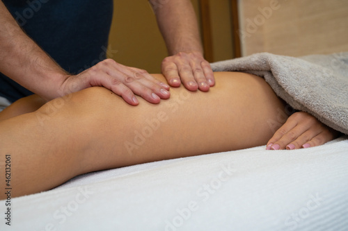 Woman getting legs lymphatic drainage massage in spa salon. Closeup. Body relaxation beauty and body care concept.