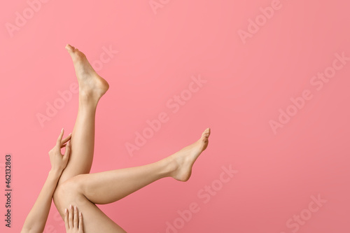 Legs of beautiful woman on color background © Pixel-Shot