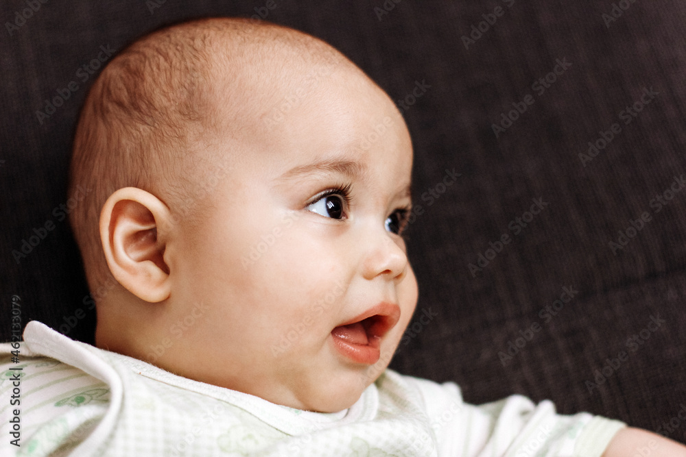 Sweet little baby boy with chubby cheeks and big eyes. Portrait of happy smiling infant Sweet little baby boy with chubby cheeks and big eyes. Portrait of happy smiling infant