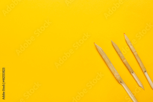 Wooden dip pens on yellow b...