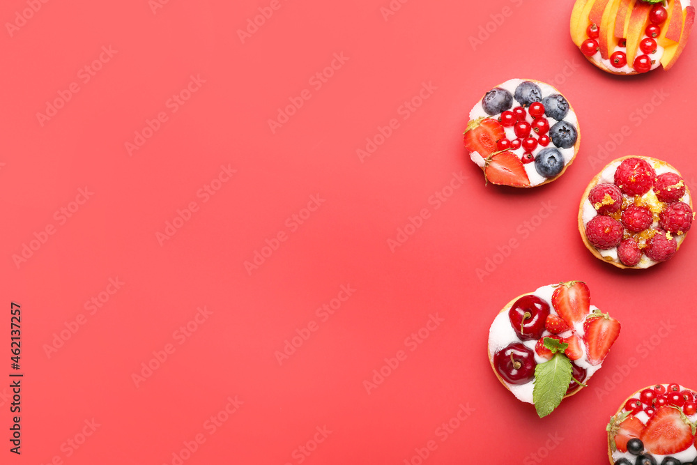 Tasty berry tartlets on color background Tasty berry tartlets on color background