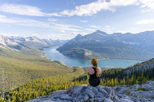 Female hiker enjoying vista on beautiful alpine valley and lake in Canadian Rockies, Rimwall Summit, Canada
