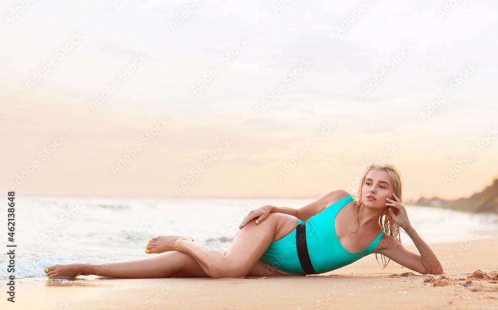 Beautiful young woman on sea beach