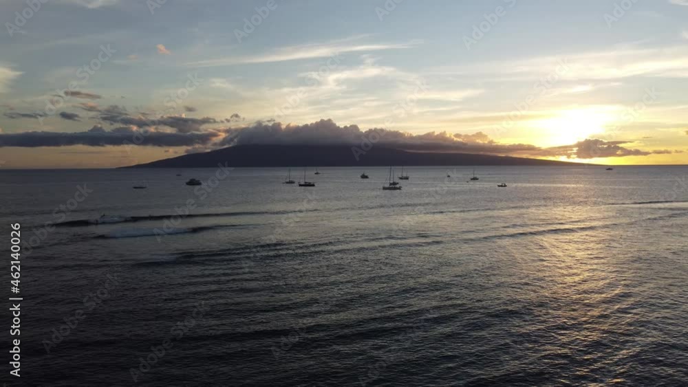Beautiful cinematic sunset shot with boats and Hawaiian islands in the background Beautiful cinematic sunset shot with boats and Hawaiian islands in the background