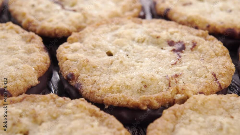 Homemade oatmeal cookies with chocolate on a wooden old table close up. Dolly shot. Homemade oatmeal cookies with chocolate on a wooden old table close up. Dolly shot.