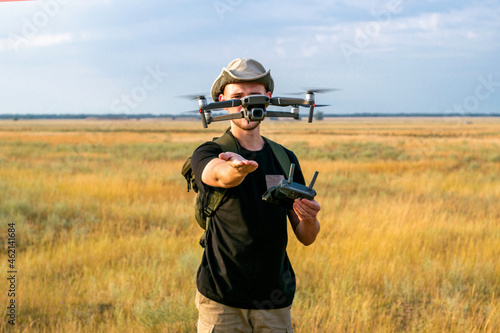 a tourist guy launches a quadcopter with his hand in front of him