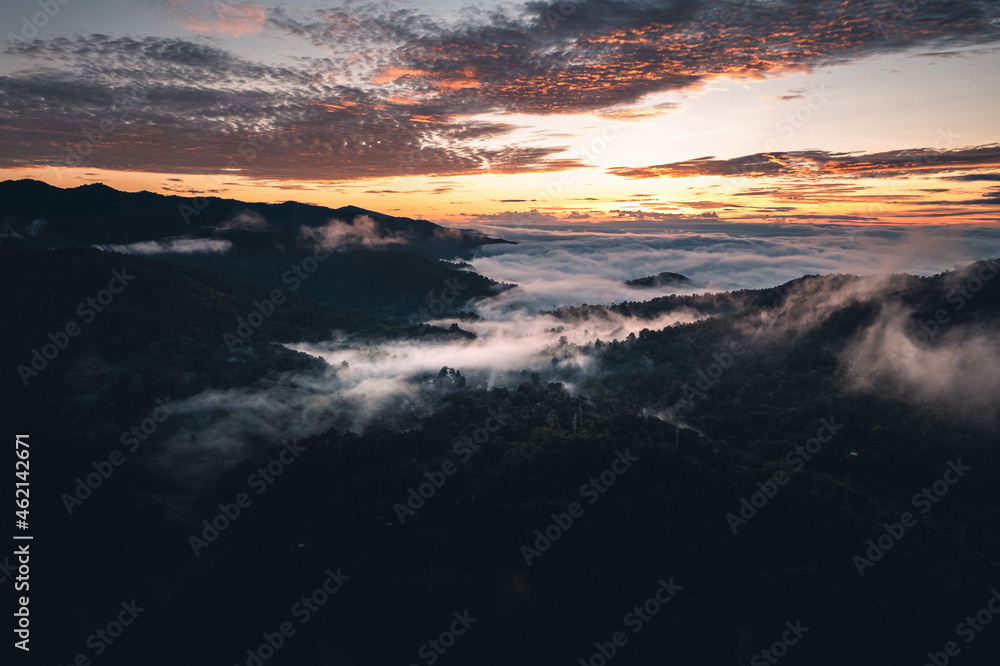 The sun rises in the mist and mountains in the morning The sun rises in the mist and mountains in the morning