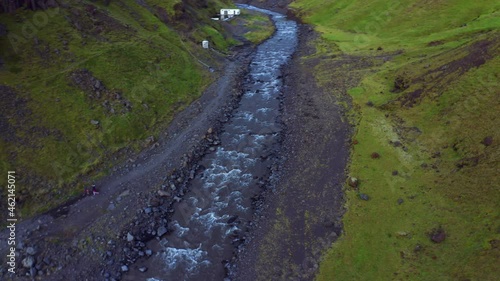 Water Flowing in The River Near Seljavallalaug Outdoor Swimming Pool In Iceland. - aerial photo