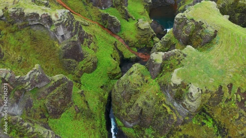 River Flowing Between Mossy Canyon Of Fjadrargljufur (Feather river canyon) In Iceland. - aerial photo