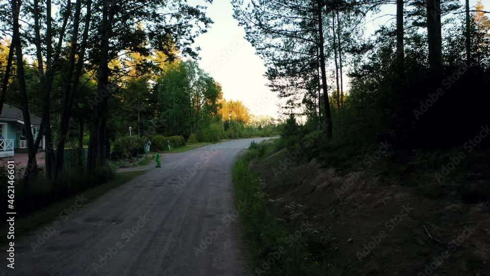 Aerial drone view of a boy afraid, running fast away from something, home, summer sunset in Scandinavia Aerial drone view of a boy afraid, running fast away from something, home, summer sunset in Scandinavia