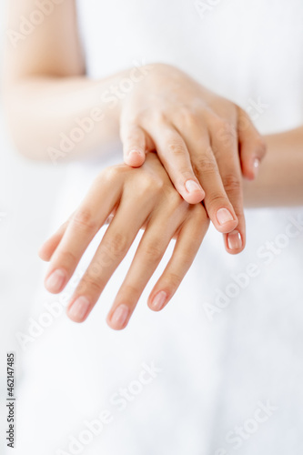 Nail care. Hand manicure. Beauty care. Closeup of woman elegant gentle palms with slender feminine fingers isolated on white background.