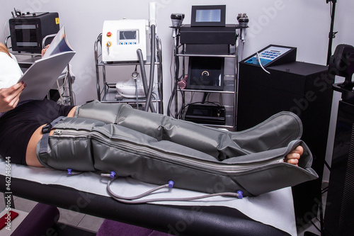 woman legs treatment with presoterapy   air compression leg massager pants