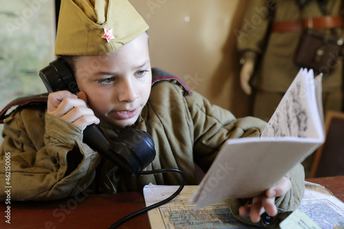 Child in uniform of red army with document photo