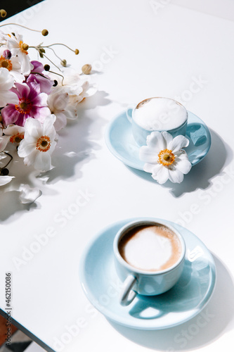 Beautiful blue vintage coffee cup with flowers and cappuccino, for lifestyle